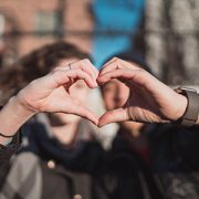 couple making heart shape with hands